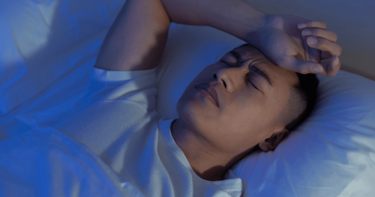 A man struggling to sleep at night due to insomnia