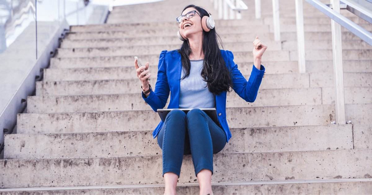 A woman listening to music with headphone on